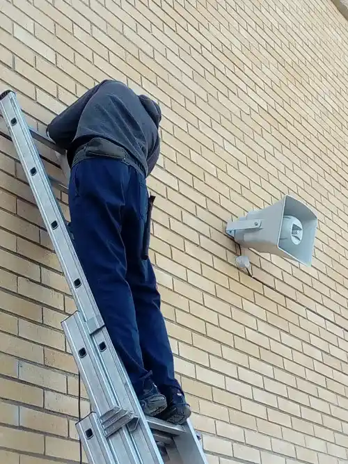 Trabajos de instalación de megafonía en el patio de un instituto